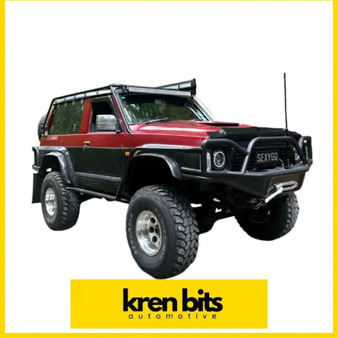 Red and black nissan safari gq y60 monsoon swb weathershield off-road suv with rugged tires roof rack and front bull bar