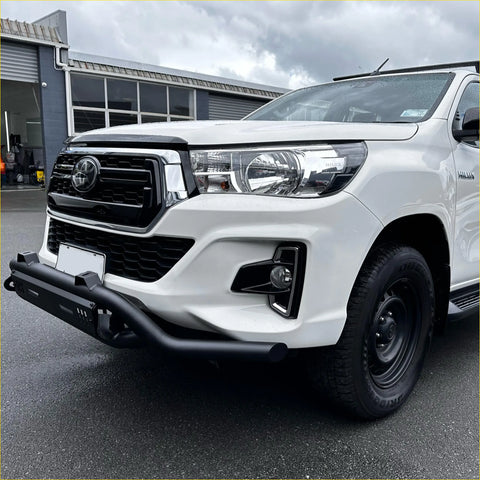 White toyota hilux with a black lower style nudge bar featuring chrome accents compatible with front camera and sensors