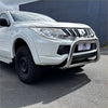Shiny chrome nudge bar with compatible front sensors mounted on white mitsubishi triton 2005-2015 pickup truck
