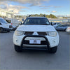 White mitsubishi triton pickup with matte black nudge bar compatible with front sensors and roof rack