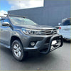 Gray metallic toyota hilux with matte nudge bar compatible with front sensors black bumper guard and roof rack