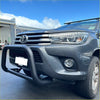 Black tubular matte nudge bar with compatible front sensors mounted on gray toyota hilux 2015-2025 front bumper