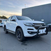 White holden colorado pickup truck with matte black nudge bar bull bar and black alloy wheels rugged front view