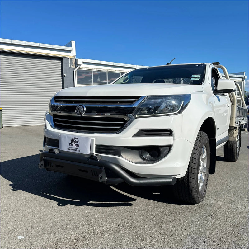 White holden colorado pickup truck with chrome grille and black front bumper featuring a nudge bar lower style