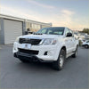 White toyota hilux pickup with black nudge bar lower style bumper guard and chrome accents 2012-2015 model