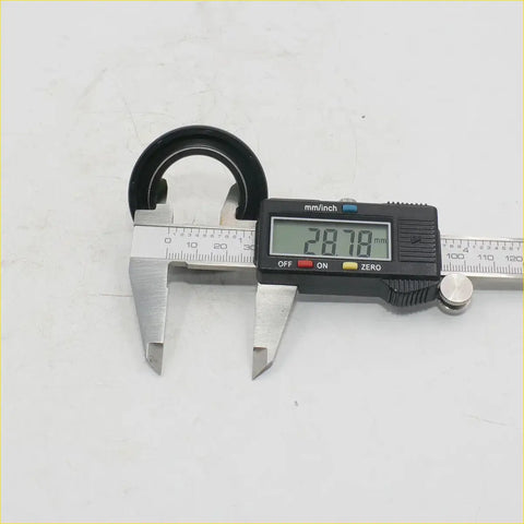 Black rubber gasket being measured with a digital caliper for power steering gear rex2 toyota hilux 2004-2016