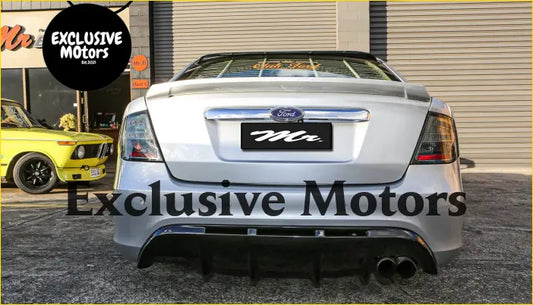 Silver ford sedan back view showing a black rear boot spoiler with dual exhaust for ford fg falcon 2008-2014