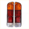 Pair of vintage-style orange and red rear bumper tail lights with clear reflector in black housing for nissan datsun 620 ute back side