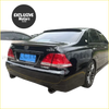 Black toyota crown sedan rear view showing glossy finish and chrome accents with rear roof spoiler installed