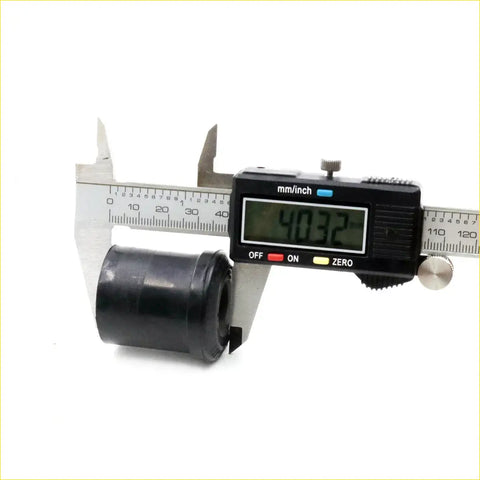 Black rubber rear spring bushing being measured with digital caliper for datsun nissan 620 1972-1979