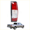 Red and clear plastic rear tail light with black housing for silver nissan frontier pickup truck back side view