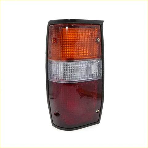 Black-framed rectangular rear tail light with amber clear and red lens sections for mitsubishi triton cyclone colt l200