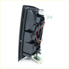 Back side of black plastic rear tail light assembly with wiring and brackets for nissan datsun d22 navara 1997-2004 left side