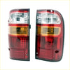 Pair of rear tail lights for toyota hilux with red and amber lenses and sleek black housing shown from the back side