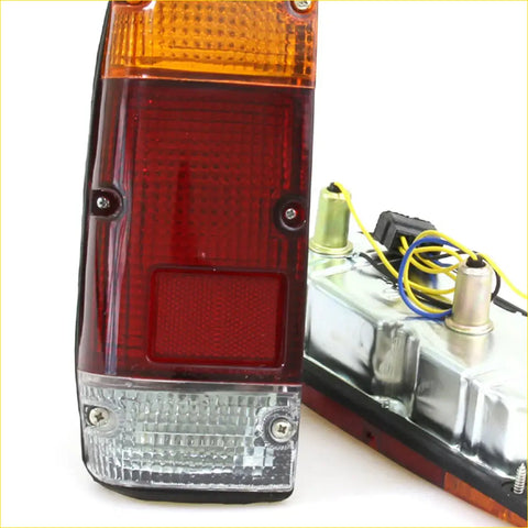 Rear tail lightset for Nissan Datsun 720 1980-1989 with red and amber plastic and clear lens at the bottom