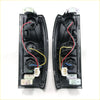 Back view of black plastic rear tail lightset side marker assemblies with wiring for nissan navara d22 ute terrano 1998-2004