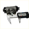 Black cast iron rear wheel brake cylinder with threaded studs measured by digital caliper for mitsubishi pajero 1983-1991