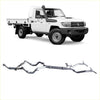 Silver metallic twin exhaust manifold system for toyota land cruiser 70 series back side shown