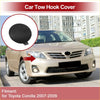 Black circular plastic tow hook cover for toyota corolla 2007-2009 shown from the back side