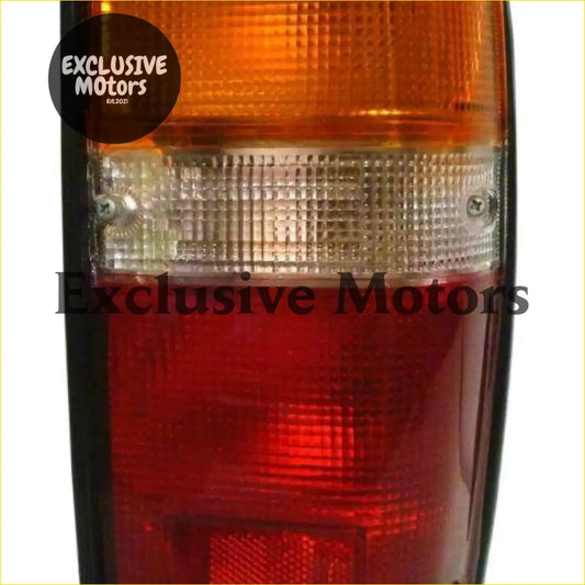 Right hand tail light for toyota hilux 1984-1988 with orange and red lenses and clear textured central strip back view
