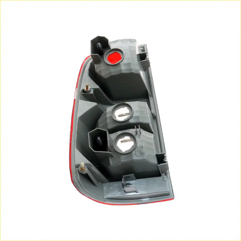 Back side of gray plastic right rear tail light for Toyota Hilux SR5 2011-2015 with red trim and three circular housings