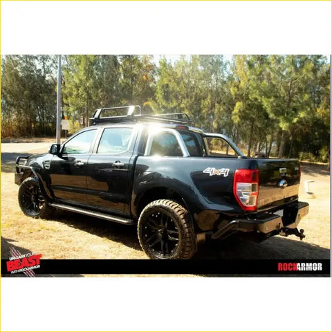Black ford ranger ute with rugged offroad tires and roof rack featuring rockarmor brushbar for 4wd use