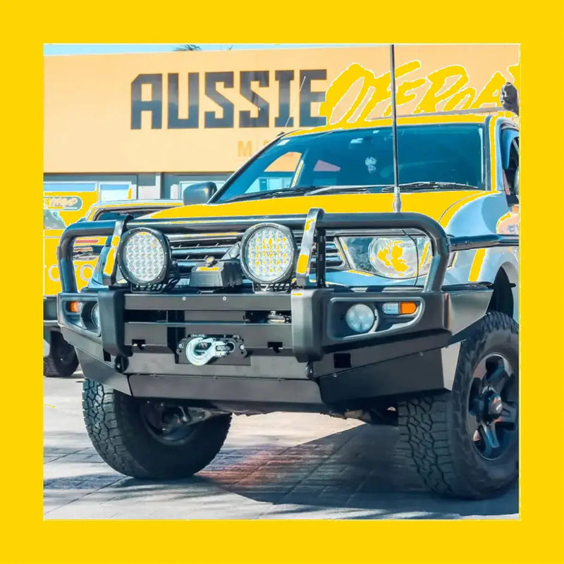 Black metal rockarmor brushbar with two circular led lights mounted on front bumper for mitsubishi triton mn ml