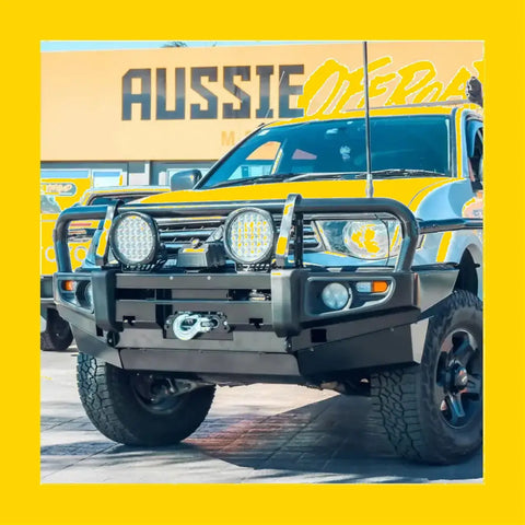 Black metal rockarmor brushbar with two circular led lights mounted for mitsubishi triton mn/ml front bumper