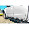 Black diamond-plate textured rockarmor brushbar side step rail mounted on white nissan navara d40 4wd ute offroad
