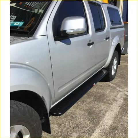 Black textured rockarmor side step for silver nissan navara d40 4wd ute offroad 2005 to 2015 model