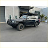 Black nissan patrol gu1 and gu4 with rockarmor brushbar, rugged offroad tires, and roof rack for 4wd adventures