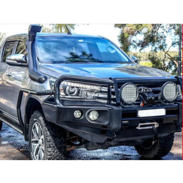 Modified gray Toyota Hilux with Rockarmor Brushbars and Rockslider accessories