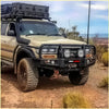 Beige toyota land cruiser with black rockarmor brushbar front bumper and roof rack for offroad 4wd ute use