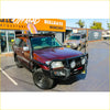 Maroon toyota land cruiser with black rockarmor brushbar front guard and roof rack perfect for 4wd offroad use