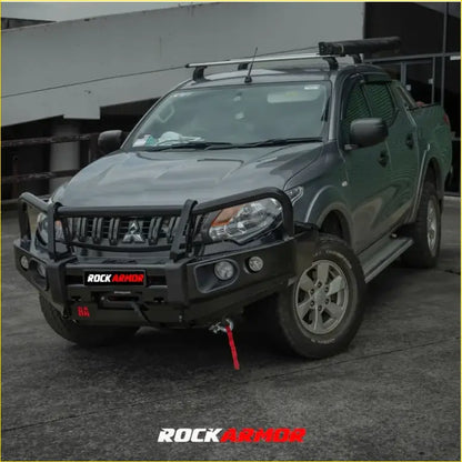 Black rockarmor elite bullbar combo pack with integrated winch and red recovery strap on dark green mitsubishi triton mq