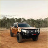Bronze nissan navara ute with black steel rockarmor elite hoop bullbar and rugged offroad tires for 4wd use