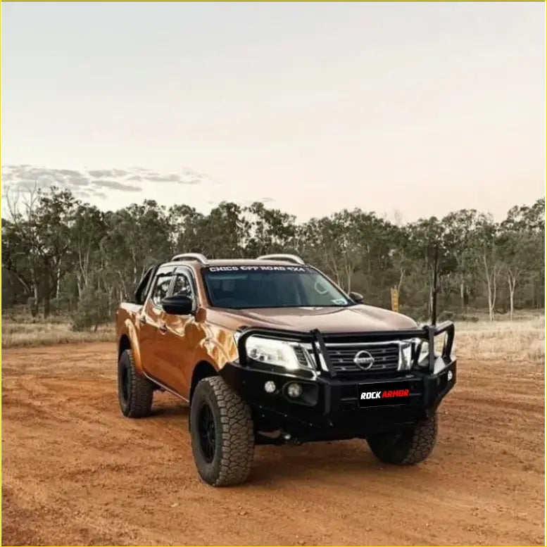 Bronze nissan navara ute with black steel rockarmor elite hoop bullbar and rugged offroad tires for 4wd use