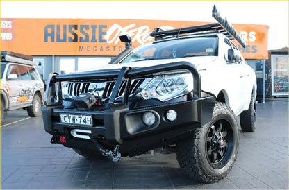 White mitsubishi triton pickup with black off-road accessories and rockarmor elite steel bullbar for tough protection