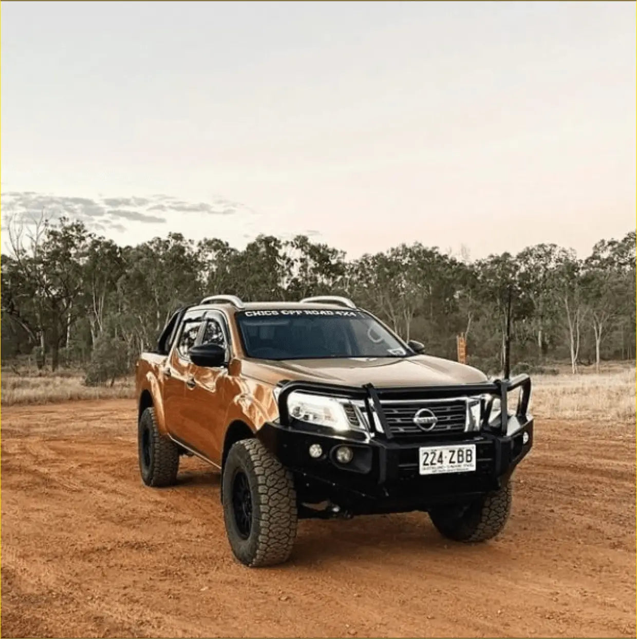 Orange nissan np300 pickup with black rockarmor elite steel bullbar and off-road tires for tough protection