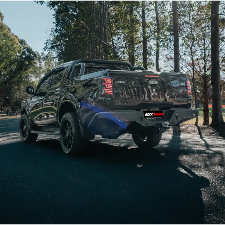 Black Mitsubishi Triton pickup truck with Rockarmor Elite Steel Rear Step Tow Bar