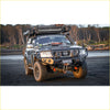 Black nissan patrol 4wd with rockarmor gt hoop bullbar combo rugged offroad tires and roof rack for ute adventures