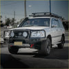 White toyota land cruiser 70 series suv with black steel rockarmor gt hoop bullbar roof rack and round auxiliary lights