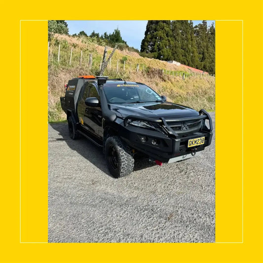 Black mitsubishi triton with rockarmor gt hoop steel bullbar full bar replacement and rugged off-road tires
