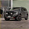Dark gray ford ranger ute with black steel rockarmor gt hoop bullbar and offroad wheels for 4wd use