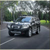 Black steel rockarmor gt hoop bullbar on toyota land cruiser 300 with rugged bumper and roof rack for offroad 4wd ute