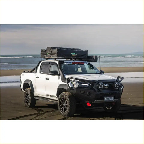 White toyota hilux ute with black steel rockarmor gt hoop bullbar and rooftop tent for offroad 4wd adventures