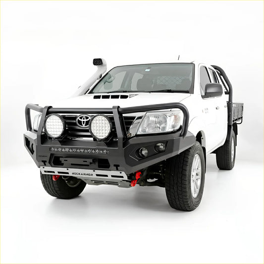 Black rockarmor gt hoop steel bullbar with integrated led and auxiliary lights on white toyota hilux n70 12-15