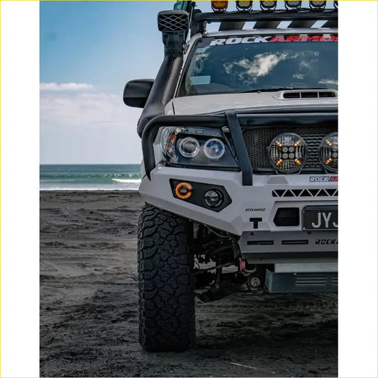 White steel rockarmor gt hoop bullbar with black accents and integrated led lights for toyota hilux n70 2005-2011