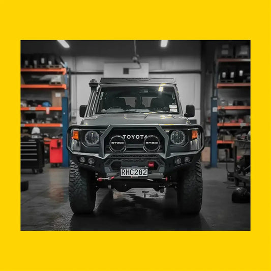 Dark gray toyota land cruiser with rockarmor gt hoop steel bullbar rugged full steel bar replacement front bumper