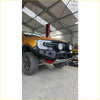 Black steel rockarmor gt hoopless bullbar with led lights and red tow hooks on orange ford ranger 4wd ute offroad
